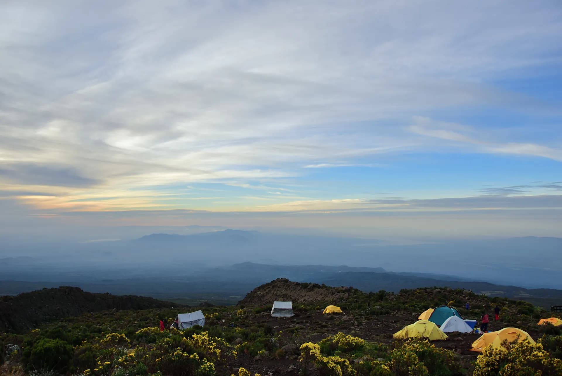Northern Circuit — Kilimanjaro camp at dusk, tents glowing orange