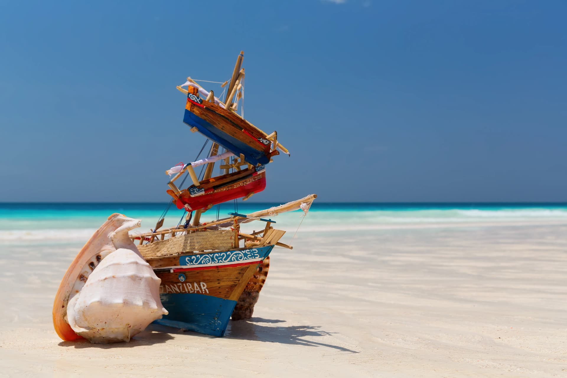 Zanzibar Archipelago — dhow boat on white sand beach